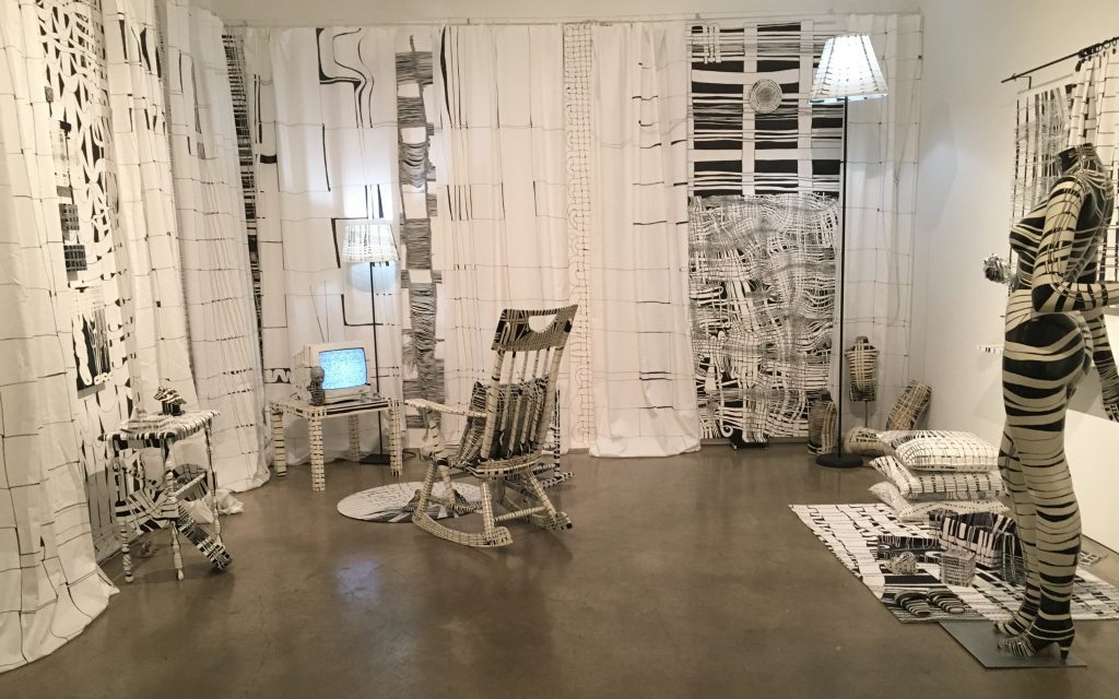 a color photograph of a white room filled with white furniture drawn on with thin and thick lines of black ink